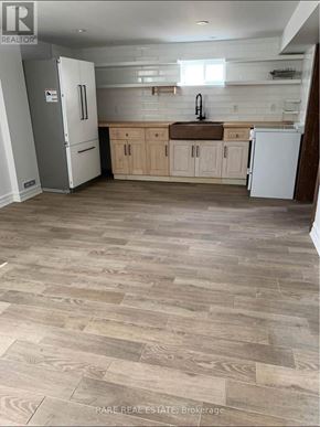 Richmond Hill (Crosby) apartment for rent - A kitchen with a white fridge and wooden cabinets.