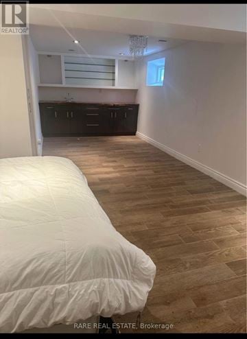 Richmond Hill (Crosby) apartment for rent - A bedroom with a bed and wooden flooring.