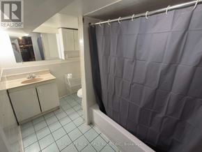 Toronto (Briar Hill-Belgravia) apartment for rent - A bathroom with a shower curtain and a sink.