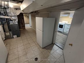 Toronto (Briar Hill-Belgravia) apartment for rent - A kitchen area with a white refrigerator and a microwave oven.
