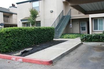 Modesto apartment for rent - A fire lane is painted red in front of a building.