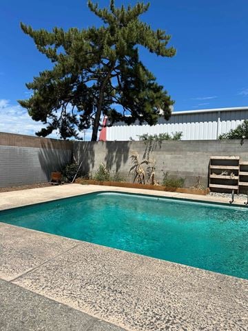 Modesto apartment for rent - A pool with a tree in the background.