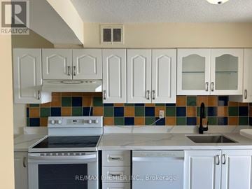 Toronto (Victoria Village) condo for rent - A kitchen with white cabinets and a stove top oven.