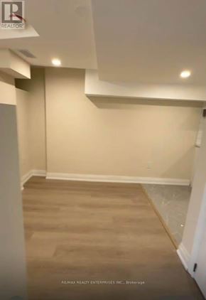 St. Catharines (Carlton/Bunting) duplex for rent - A room with beige walls and a wooden floor.