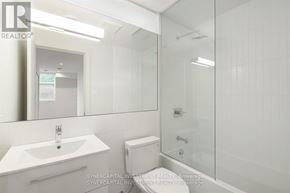 Ottawa townhouse for rent - A white bathroom with a sink, toilet, and shower.
