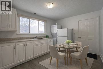 Kitchener apartment for rent - A kitchen with a table set for two and a refrigerator.