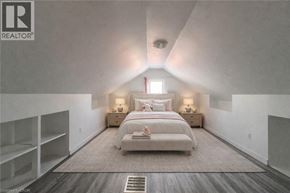 Kitchener apartment for rent - A bedroom with a large bed and a window.