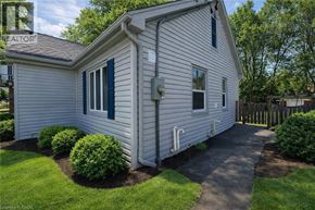 Kitchener apartment for rent - A house with a white siding and a green window trim.