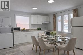 Kitchener apartment for rent - A modern kitchen with a dining table set for two.