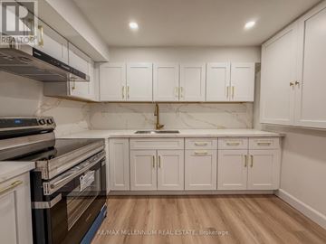 Ajax (South East) apartment for rent - A kitchen with white cabinets and a marble backsplash.