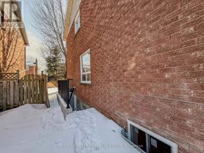 Ajax (South East) apartment for rent - A red brick building with a window and snow on the ground.