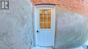 Ajax (South East) apartment for rent - A white door with a glass window is set in a brick wall.