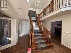 Aurora (Aurora Highlands) apartment for rent - A staircase with a wooden banister and a chandelier above it.