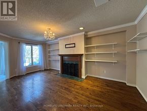 Aurora (Aurora Highlands) apartment for rent - A large, empty room with a fireplace and a chandelier.
