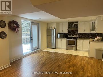 Markham (Unionville) apartment for rent - A kitchen with wooden floors and white cabinets.