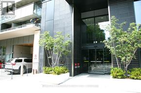 Toronto (Church-Yonge Corridor) condo for rent - A modern building with glass doors and windows, and a tree in front.
