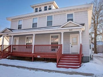 Eau Claire apartment for rent - A two-story house with a red front porch.