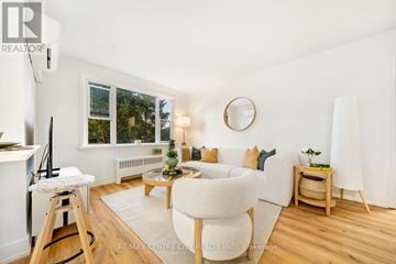 St. Thomas condo for rent - A living room with a white couch and a wooden floor.