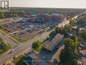 St. Thomas condo for rent - A parking lot with a building in the background and a sign that says RE/MAX CENTRE CITY REALTY INC. Brokerage.