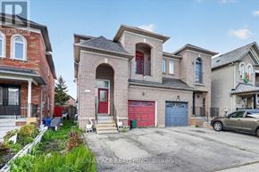 Vaughan (East Woodbridge) apartment for rent - A house with a red door and a blue garage door is for sale.