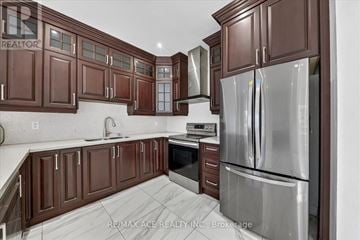 Vaughan (East Woodbridge) apartment for rent - A kitchen with brown cabinets and a stainless steel refrigerator.