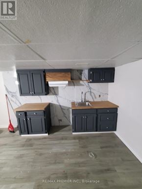 Orillia townhouse for rent - A kitchen with a white wall and a wooden counter top.
