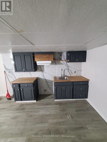Orillia townhouse for rent - A kitchen with a white wall and a wooden counter top.