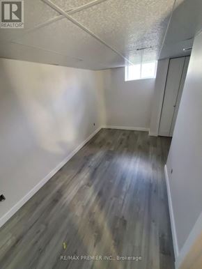 Orillia townhouse for rent - A hallway with wood flooring and white walls.