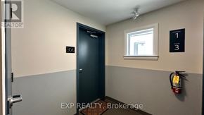 Ottawa apartment for rent - A brokerage office with a door labeled 200 and a fire extinguisher on the wall.