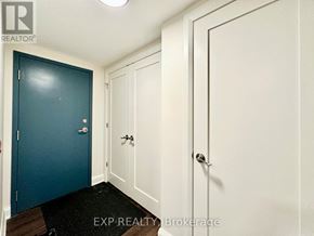 Ottawa apartment for rent - A hallway with a blue door and white walls.