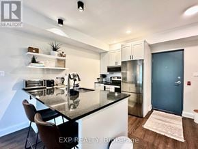 Ottawa apartment for rent - A modern kitchen with a black countertop and stainless steel appliances.