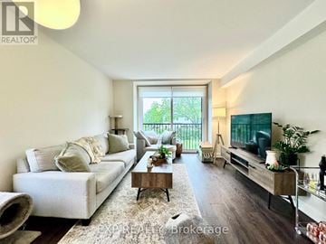 Ottawa apartment for rent - A living room with a white couch and a flat screen TV.