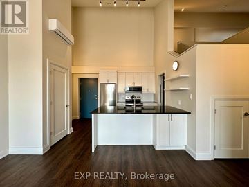 Ottawa apartment for rent - A kitchen with white cabinets and a black countertop.