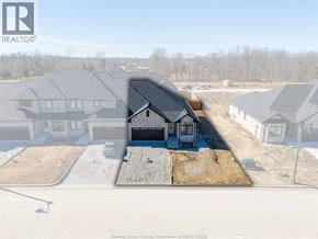 Amherstburg townhouse for rent - A real estate company logo is displayed on a construction site.