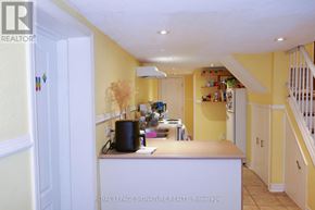 Toronto (Dovercourt-Wallace Emerson-Junction) apartment for rent - A kitchen with yellow walls and white cabinets.