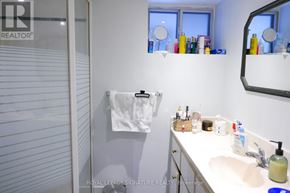 Toronto (Dovercourt-Wallace Emerson-Junction) apartment for rent - A white bathroom with a white sink and a white towel hanging on the wall.