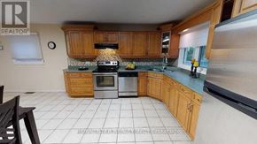 London North (North K) apartment for rent - A kitchen with wooden cabinets and a stove top oven.