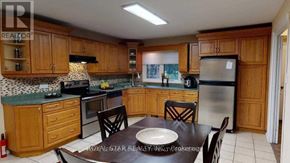 London North (North K) apartment for rent - A kitchen with wooden cabinets and a black and white tiled backsplash.