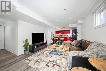 Richmond Hill (Devonsleigh) apartment for rent - A living room with a brown leather couch and a wooden floor.