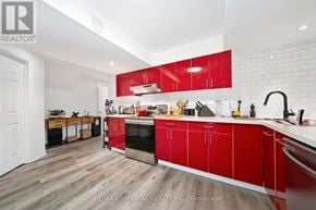 Richmond Hill (Devonsleigh) apartment for rent - A kitchen with red cabinets and a white countertop.