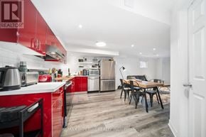 Richmond Hill (Devonsleigh) apartment for rent - A kitchen with red cabinets and a dining table.