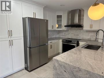 Lasalle apartment for rent - A kitchen with a refrigerator, sink, and stove.