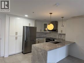 Lasalle apartment for rent - A kitchen with a refrigerator, cabinets, and a marble countertop.
