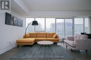 Ottawa condo for rent - A living room with a yellow couch and a grey rug.