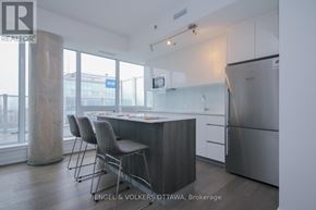 Ottawa condo for rent - A modern kitchen with a dining table and chairs.