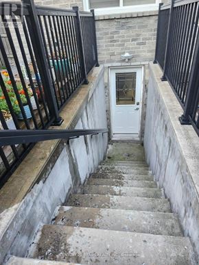 Ajax (Central) apartment for rent - A set of stairs leading to a white door with a glass window.