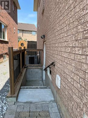 Markham (Wismer) apartment for rent - A brick wall with a small white sign on it.