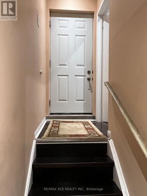 Markham (Wismer) apartment for rent - A white door with a black staircase leading to it.