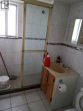 Vancouver apartment for rent - A bathroom with a sink, toilet, and a shower with a glass door.