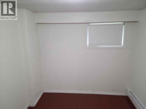 Vancouver apartment for rent - A small room with a window and a brown floor.